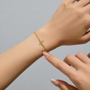 Close-up of a gold-plated silver butterfly bracelet with sparkling zircon stones on wrist