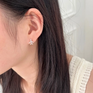 Close-up of S925 sterling silver airplane stud earrings with pavé zircon wings