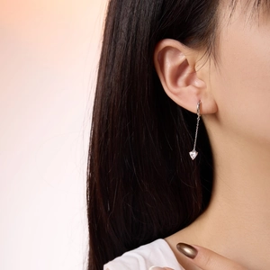Macro close-up of S925 sterling silver tassel earrings with clear heart-shaped zircon