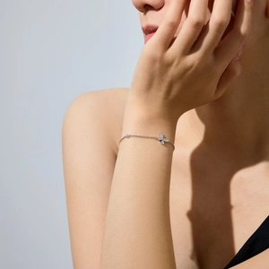 Detail of S925 sterling silver butterfly bracelet with shimmering pave zircons on wrist