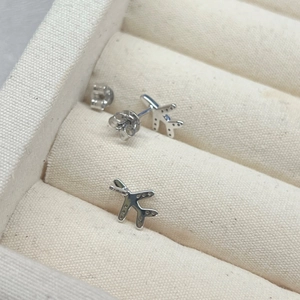 S925 sterling silver airplane stud earrings set in a beige velvet jewelry box