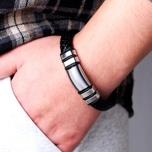 Men's minimalist black braided leather bracelet with polished stainless steel accents