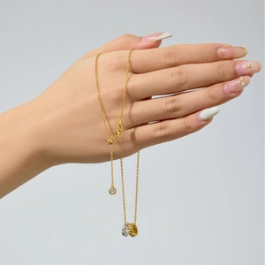 Macro detail of interlocking two-tone rings with textured gold and pavé silver finishes