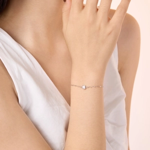 Close-up of elegant S925 sterling silver chain bracelet with a sparkling round zircon