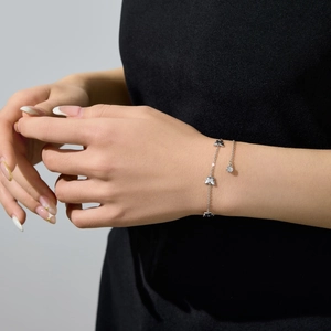 Minimalist S925 sterling silver butterfly bracelet with monochrome charms on a wrist