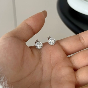Detailed macro shot of S925 sterling silver halo stud earrings with brilliant Moissanite