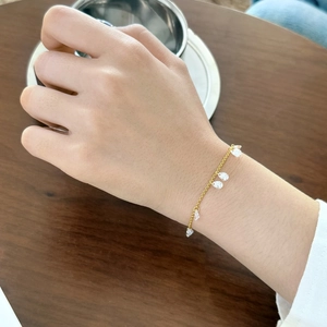Detail view of S925 sterling silver gold bracelet with crystal water drop pendants