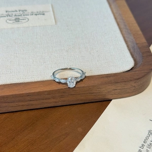 Macro shot of oval cut center stone with marquise side diamonds on S925 silver ring
