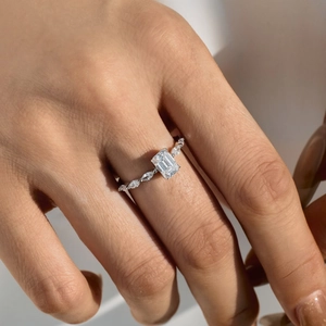 Macro view of S925 sterling silver ring with emerald-cut stone and marquise accents