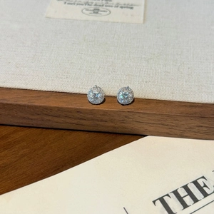 Macro view of S925 sterling silver halo stud earrings with brilliant round moissanite