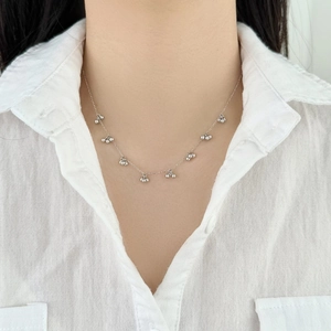 Elegant S925 sterling silver necklace with cherry bead charms worn on a white linen shirt