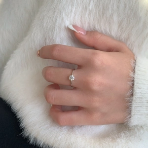 Detailed view of 0.5ct moissanite solitaire ring on model with classic six-prong setting