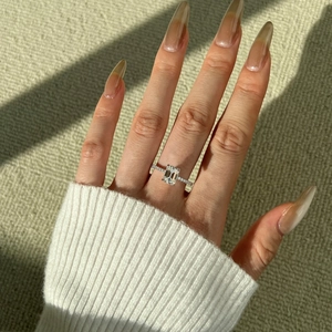 Detail of 2 carat emerald cut moissanite ring with a micro-pave S925 silver band