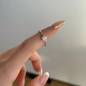 Detail of a 0.5 carat moissanite ring with classic six-prong setting on a female hand
