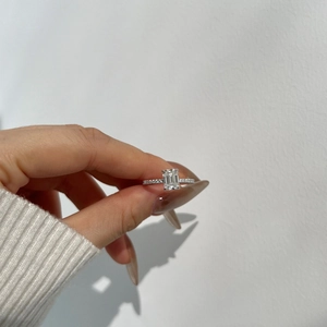 Macro shot of 2-carat emerald cut moissanite ring with a micro-pave diamond band