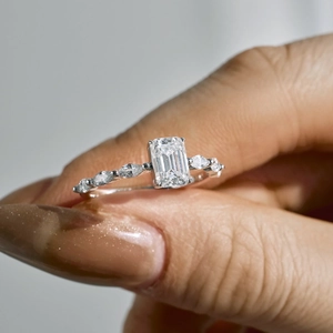 S925 sterling silver emerald cut moissanite ring with side stones on hand