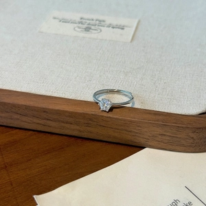 Detailed view of 0.5ct Moissanite solitaire ring with 6-prong silver setting and open band