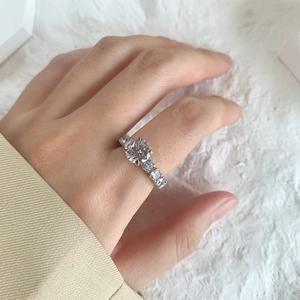 Macro detail of 2 carat sparkling silver wedding ring with six-prong set round diamond