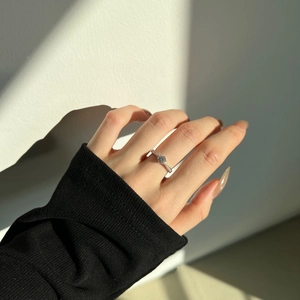 Close-up of S925 silver ring on hand featuring a 0.5ct diamond with side stones