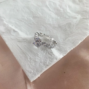 Macro shot of S925 sterling silver ring hallmark and sparkling small pavé side diamonds