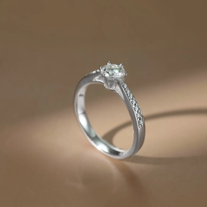 Detailed view of 0.5 carat Moissanite ring with six-prong setting and side diamonds