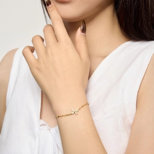 Close-up of golden butterfly bracelet with shimmering cubic zirconia on female wrist