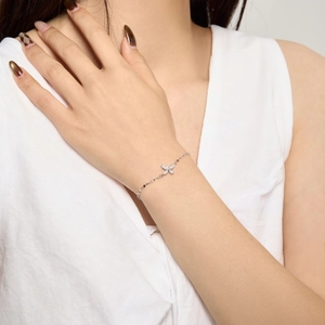 Macro detail of S925 silver butterfly bracelet featuring sparkling pavé cubic zirconia