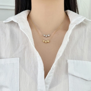 Minimalist S925 sterling silver layered necklace with polished beads on a gold and silver chain