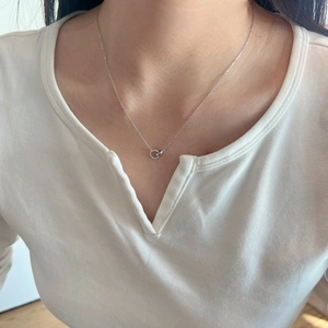 Detail of S925 sterling silver interlocking double ring necklace on a female model