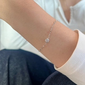 Detailed view of an S925 silver minimalist bracelet with a bezel-set round diamond stone
