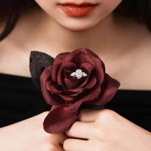 Three-stone S925 silver ring featuring oval and pear cut moissanite on red rose