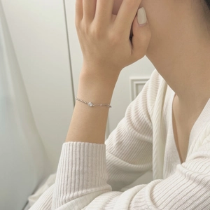 Close-up of S925 sterling silver asymmetrical bead and link chain bracelet on a wrist