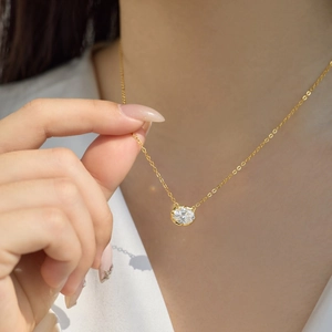 Close-up of elegant S925 silver gold-plated necklace with a brilliant round pendant