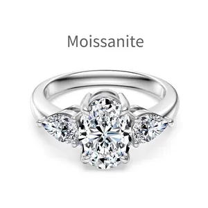 Three-stone Moissanite ring featuring oval center stone and pear-shaped side diamonds
