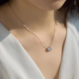 Close-up of sparkling round-cut pendant necklace on neck for elegant daily wear