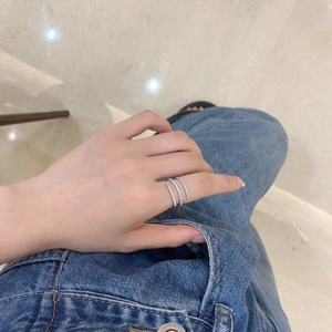Macro shot of silver spiral ring with micro-pave crystals on the hand against denim