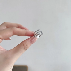 Macro shot of triple layered S925 sterling silver ring featuring pave set white cubic zirconia