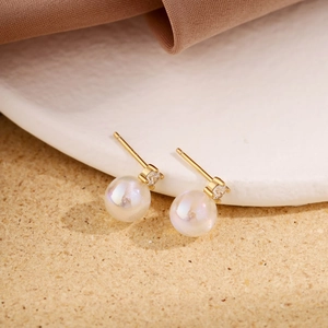 Detailed close-up of S925 sterling silver moonstone stud earrings with sparkling cubic zirconia