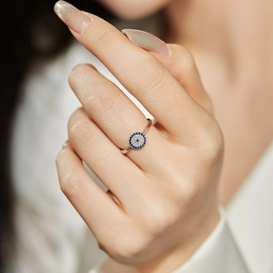 Elegant S925 sterling silver evil eye ring featuring blue zircon stones on a model hand