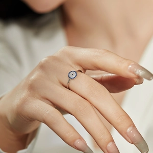 S925 silver evil eye ring featuring blue and white zircons on model hand
