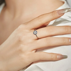 Close-up of S925 silver ring featuring blue and white zircon Evil Eye motif on a model