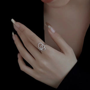 Luxurious S925 silver ring with butterfly design and zircon inlays on a black background