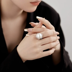 Luxurious S925 silver ring featuring a large white pearl and zircon pavé bow design