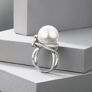 Close-up of a luxury S925 silver bow ring with a large white pearl and zircon accents