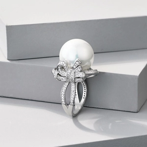 Macro shot of S925 sterling silver stamp on pearl bow ring with zircon pavé
