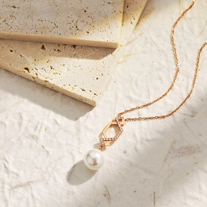 Close-up of rose gold S925 sterling silver necklace with zircon and fresh water pearl