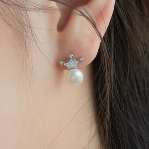 Close-up of S925 silver crown earrings with freshwater pearl on woman's ear