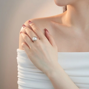Elegant freshwater pearl ring on woman finger with minimalist silver setting