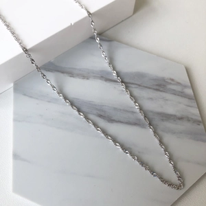 Minimalist S925 sterling silver necklace for women with wave chain on marble display