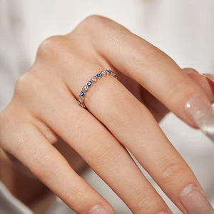 Macro detail of S925 sterling silver evil eye ring with blue enamel and heart zircon